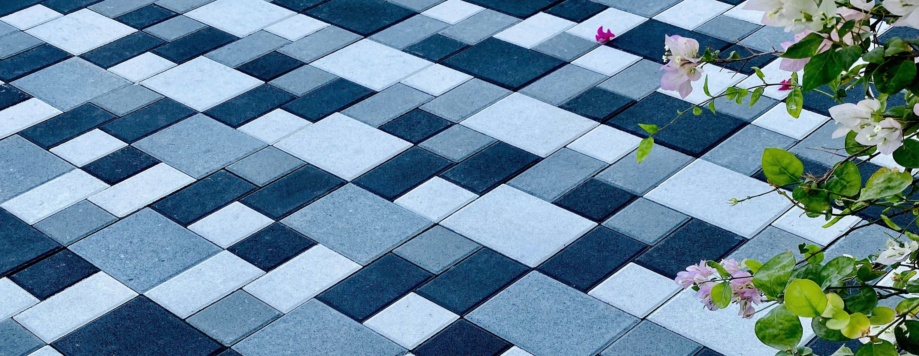 Diamond pattern blue and white concrete pavers in landscape design